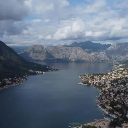 Stunning aerial photograph of Kotor Bay, Montenegro, showcasing coastal architecture and mountainous landscape.