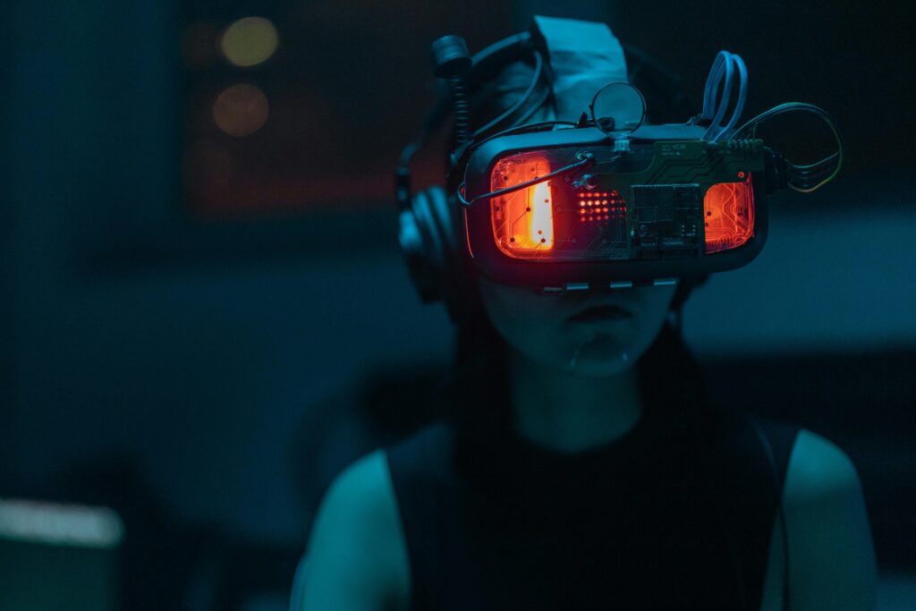A woman immersed in a virtual reality experience with a high-tech VR headset in a dimly lit room.